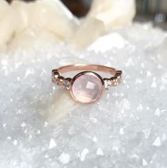 Rose cut rose quartz ring set in 925 Sterling silver with 4 large bezel set crystals down each side and plated in rose gold. Rose Quartz Crystals 14k rose gold over sterling silver Center stone: 8mm Rosegold Ring, Crystals Quartz, Moon Bracelet, Hand Necklace, Rose Quartz Ring, Professional Jewelry, Ring Fashion, Crystal Choker, Green Opal