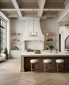 a large kitchen with white cabinets and marble counter tops, along with wooden flooring