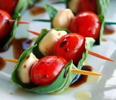 small appetizers with tomatoes and cheese on toothpicks are ready to be eaten