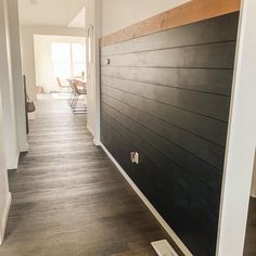 an empty hallway with wood paneling on the wall