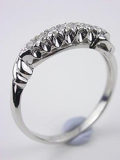 a white gold ring with five diamonds