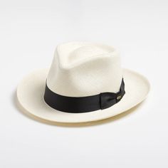 This bleached white panama fedora is a real looker. It has a teardrop crown and features wire in the brim for minor shape adjustments. Brim can be worn as shown in the picture or "snapped" up. It comes finished with a 16-Ligne grosgrain ribbon around the crown, a discrete bow and a removable Scala emblem. Additional information: Scala Panamas come with an "uncrushable" insert in the crown which prevents cracking from normal wear and tear. In addtion they come finished with a tefllon coating to repel mild water and oil based spills. Brim: 2 5/8" Crown: Front: 4" Side: 4 1/2"