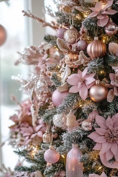 a christmas tree decorated with pink and gold ornaments