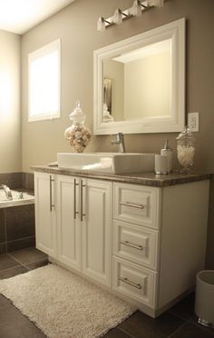 a bathroom with a sink, mirror and bathtub