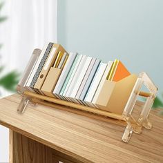 a stack of books sitting on top of a wooden desk