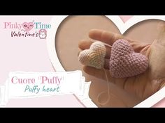 there is a small crocheted heart in the palm of someone's hand