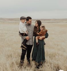 a family standing in the middle of a field