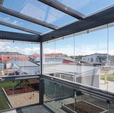 the inside of a glass walled building with lots of windows