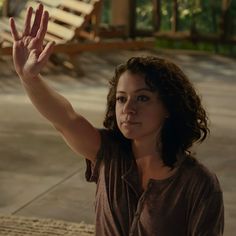 a woman with her hand up in the air