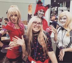 three women dressed in costumes posing for a photo with their hands up to the camera