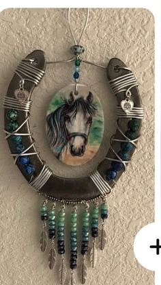 an image of a horse in the middle of a circle with beads hanging from it