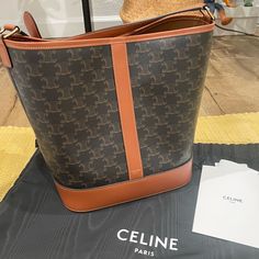 It’s Basically New. Never Worn Other Than Trying On At Home. I Have Receipt And Tag. Comes With Dust Bag. 9 X 11 X 7 In (24 X 27 X 18 Cm) Celine Canvas Bucket Bag, Elegant Brown Bag With Lined Interior, Celine Bucket Bag, Cell Phone Holster, Soft Cooler, Phone Holster, Celine Bags, Walker Boots, Garment Bags