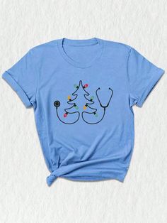 a blue t - shirt with two christmas trees on the front and one is wearing a stethoscope