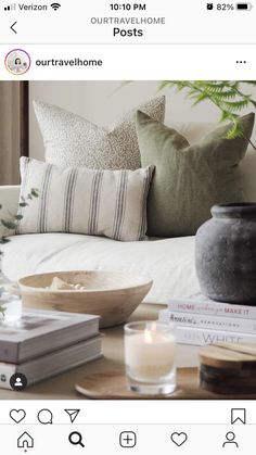 a bed with pillows and candles on top of it