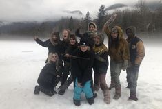 a group of people standing in the snow