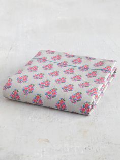 a folded sheet with pink and blue flowers on it