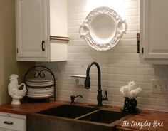 a white brick wall in a kitchen with black and white accessories on the counter top