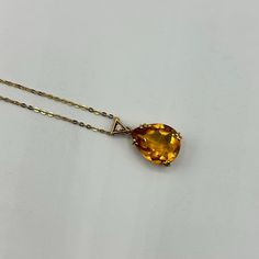 This stunning necklace features an exquisite teardrop-shaped citrine gemstone that radiates a warm, golden hue, beautifully set in 18K yellow gold. The pendant is elegantly adorned with a round diamond accent, adding a touch of sparkle and sophistication. The citrine, known for its vibrant color and clarity, is securely held by four prongs, allowing the stone to catch and reflect light from every angle. The pendant hangs gracefully from an 18-inch, 1mm chain, offering a delicate yet sturdy design that complements the vibrant gemstone. Weighing 4.47 grams, this necklace is a perfect blend of luxury and elegance, making it an ideal accessory for any occasion or a thoughtful gift for someone special. Luxury Citrine Necklaces With Diamond Accents, Formal Teardrop Gemstone Necklace, Formal Teardrop Pendant Drop Necklace With Gemstone, Fine Jewelry Teardrop Pendant Drop Necklace With Gemstone, Fine Jewelry Yellow Gold Pear-shaped Necklace, Formal Teardrop Pendant Jewelry With Faceted Details, Formal Teardrop Pendant Necklace With Faceted Detail, Elegant Citrine Necklace With Polished Finish, Fine Jewelry Yellow Gold Pear Necklace