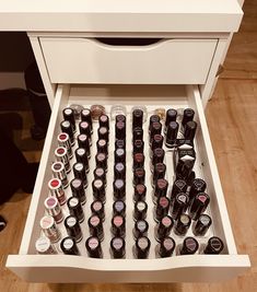 an open drawer filled with lots of bottles