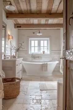 a white bath tub sitting under a window in a bathroom