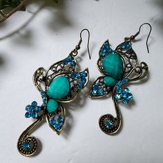 Beautiful Butterfly Earrings Turquoise Blue In Color Set In Antique Goldtone Alloy Hook Style New #31 Boho Bohemian Hippie Gypsy Casual Dressy Wedding Event Work Summer Fairycore Blue Bohemian Crystal Drop Earrings, Bohemian Blue Crystal Drop Earrings, Blue Metal Crystal Earrings, Blue Crystal Metal Earrings For Pierced Ears, Blue Bohemian Crystal Earrings, Bohemian Blue Crystal Earrings, Summer Fairycore, Butterfly Dangle Earrings, Rose Gold Drop Earrings