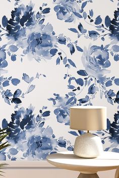 a lamp on a table in front of a blue flowered wallpaper with white background