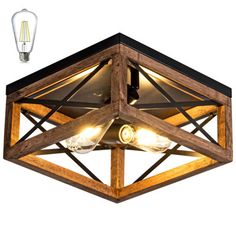 a wooden light fixture with two lights on it's sides and an open bulb in the middle