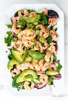 shrimp salad with avocado and cilantro dressing on a white platter