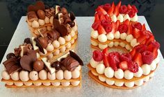 two cakes are decorated with strawberries and chocolate