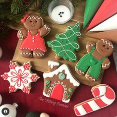 decorated christmas cookies on a table with decorations