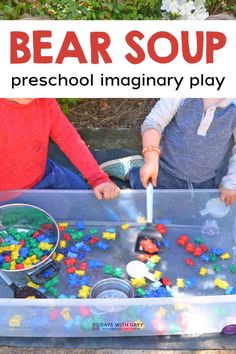 two children playing with bear soup in an outdoor play area that is made out of plastic beads