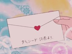 someone holding an envelope with a heart on it