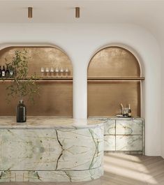 an elegant bar with marble counter tops and gold accents