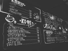 black and white photograph of menus on the wall