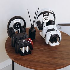 two video game controllers sitting on top of a wooden table