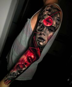 a man's arm with a half sleeve tattoo on it and two red eyes