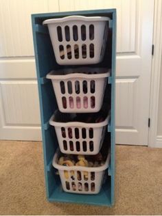 three plastic baskets stacked on top of each other in front of a blue shelf filled with food