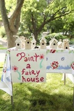 an image of a party table with decorations on it and a sign that says paint a fairy house