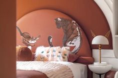 an animal themed bedroom with orange walls and white bedding, along with decorative artwork on the wall