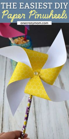 a pinwheel made out of paper with text overlay that reads, the easyest diy paper pinwheels