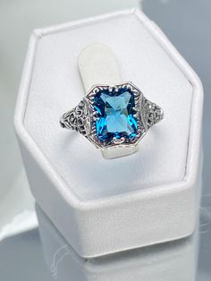 London Blue Topaz Ring, Lovely Rectangle, Victorian Jewelry, Edwardian style, Silver Embrace Jewelry, D148 Blue Square Cut Topaz Ring, Blue Topaz Ring With Square Cut, Blue Topaz Ring With Square Cut Gemstone, Rectangular Topaz Ring Fine Jewelry Gift, Rectangular Topaz Ring As Gift, Fine Jewelry Style, Fine Jewelry Topaz Ring With Rectangular Stone For Gift, Blue Radiant Cut Topaz Ring Fine Jewelry, Blue Emerald Cut Birthstone Jewelry, Radiant Cut Blue Topaz Jewelry For Formal Occasions