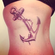 an anchor tattoo on the side of a woman's stomach