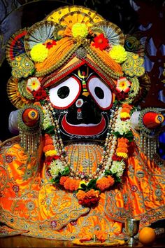 an elaborately decorated mask with flowers on it