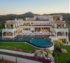 an aerial view of a large home with a pool