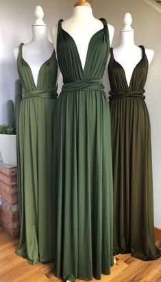 three green bridesmaid dresses on mannequins