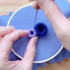 someone is making a blue and purple piece of felt