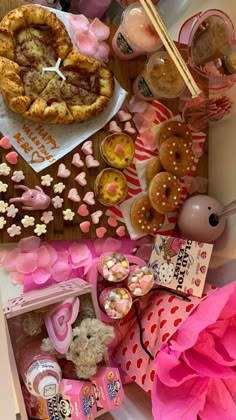 a table topped with lots of different types of food and desserts on top of it