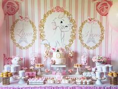 a pink and white dessert table with balloons