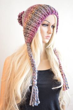 a woman with long blonde hair wearing a knitted hat