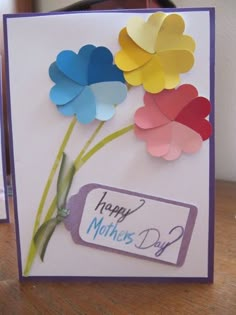 a mother's day card with three paper flowers